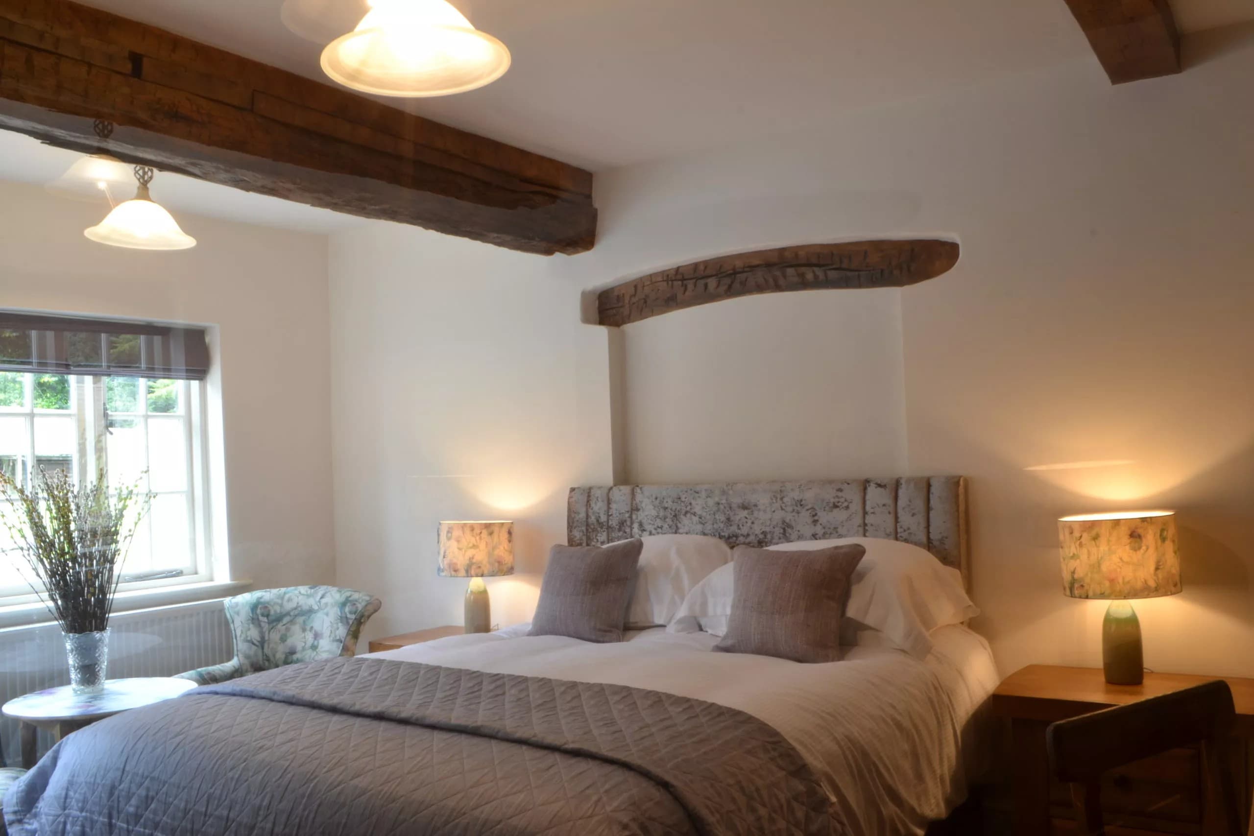 Character bedroom with original curved oak beam